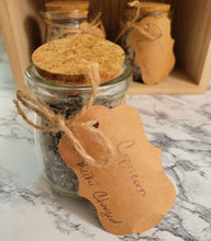 Load image into Gallery viewer, Close up of a jar of Capricorn-inspired, reiki-charged bath salts in 4 oz glass jar with cork and paper tag.