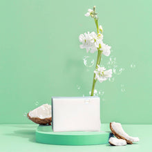 Load image into Gallery viewer, A bar of Green Llama dish soap featured against a green background with coconut pieces.
