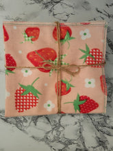 Load image into Gallery viewer, Close up of reusable unpaper towel in strawberry pattern. Wrapped in twine. Made in Montgomery County, MD