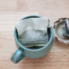Load image into Gallery viewer, A reusable Farm Girl Cloth tea bag in a mug