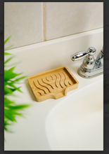 Load image into Gallery viewer, A bamboo soap dish with a wavy pattern to keep soap elevated and a slight spout for draining.