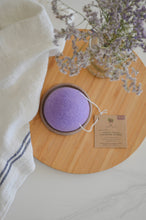 Load image into Gallery viewer, Flatlay of lavender facial cleansing sponge