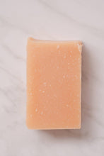 Load image into Gallery viewer, A close up of a single bar of peach colored, vegan, no-waste Citrus sunshine soap from NoToxLife