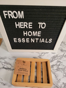 A Bamboo soap shelf sits on a table.