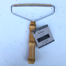 Load image into Gallery viewer, Close up of zero-waste bamboo lint remover. Endlessly reusable.
