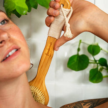 Load image into Gallery viewer, Person in shower demonstrating one use of bamboo dry brush, to clean back
