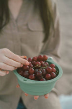 Load image into Gallery viewer, Using a collapsible bowl as a camping bowl to hold grapes. 
