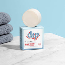 Load image into Gallery viewer, The round face wash bar rests on top of the dip Fragrance Free Face Wash box.

