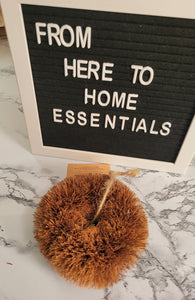 A heavy-duty coconut pot scrubber sits on a table