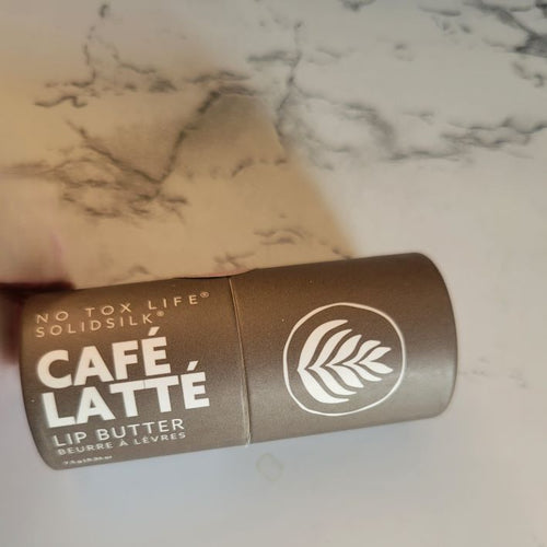 A brown paperboard tube of No Tox Life lip butter in 