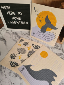 Three reusable, machine washable Swedish dishcloths in Ocean theme on a table.