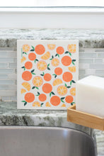 Load image into Gallery viewer, Swedish dishcloth covered in a pattern of oranges on a sink
