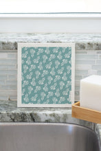 Load image into Gallery viewer, Image of single washcloud in Kleen Kelp pattern sitting on sink.
