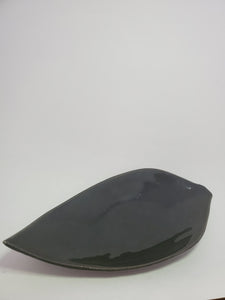 A black, high gloss, leaf shaped ceramic plate made in Cambodia.