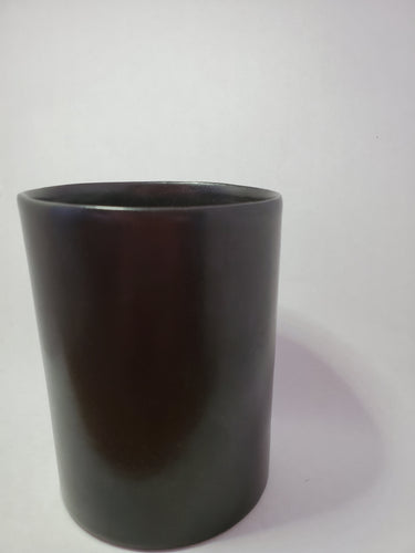 A sleek black mug without a handle handmade in Cambodia