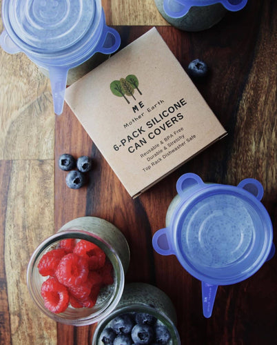 Image shows blue, stretchy, reusable can covers on a variety of different sized jars. 