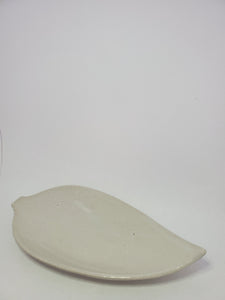 A high gloss white leaf shaped plate handmade in Cambodia